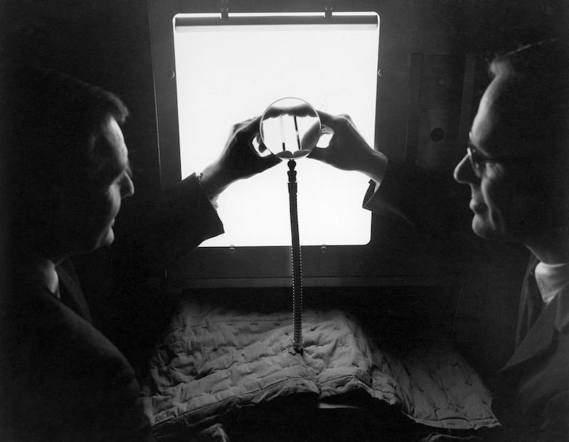 Two men, Hap Johnson (left) and Brock Barkley (right) examine test specimens from an experimental run