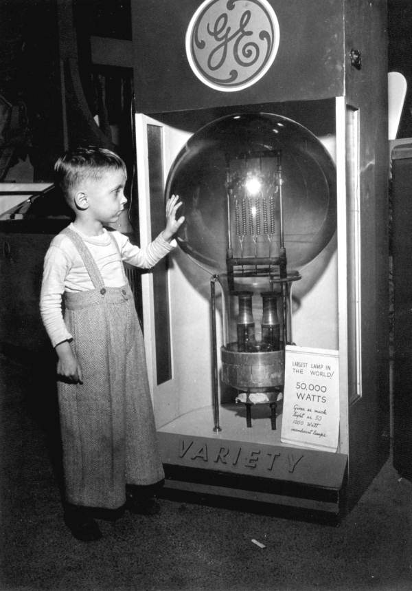 Tommy Dodgen, a four year old boy, stands by the largest lamp in the world: Tampa, Florida